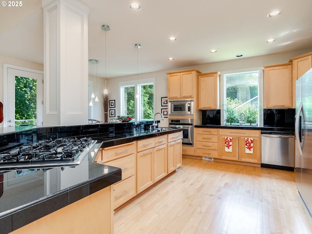 4374 M Loop, Washougal, WA 98671 - kitchen featuring stainless steel appliances, light brown cabinetry, dark countertops, light wood-type flooring, and recessed lighting