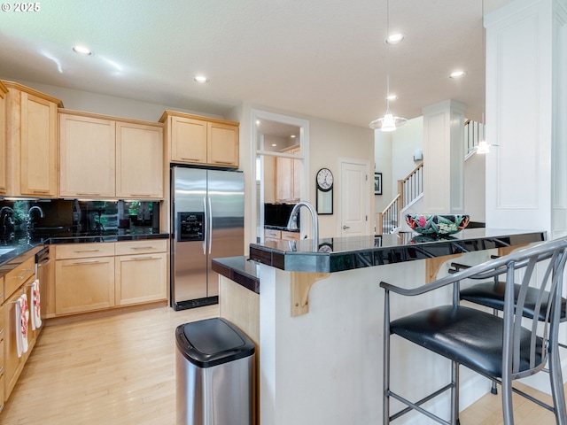 4374 M Loop, Washougal, WA 98671 - kitchen with stainless steel fridge with ice dispenser, light brown cabinets, dark countertops, and recessed lighting