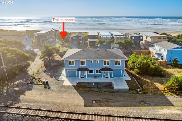 aerial view featuring a water view and a view of the beach