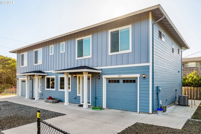 view of front property featuring central air condition unit and a garage