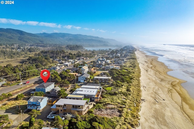 aerial view featuring a water and mountain view and a beach view