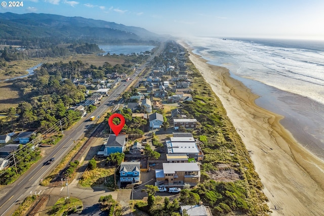 aerial view with a water and mountain view and a beach view