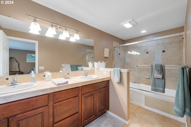 bathroom with tile patterned floors, vanity, and enclosed tub / shower combo