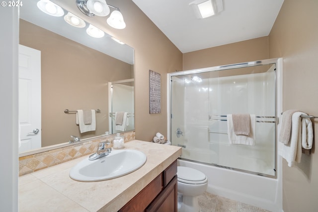 full bathroom with enclosed tub / shower combo, vanity, toilet, and tile patterned floors