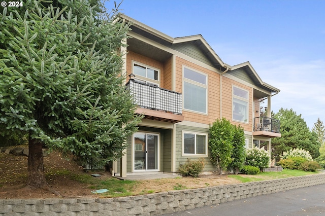 back of property with a balcony