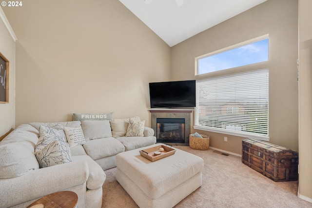 living room with light carpet and high vaulted ceiling