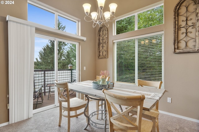 dining area with a notable chandelier, carpet floors, and a wealth of natural light