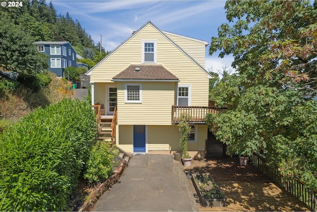 back of property with a wooden deck