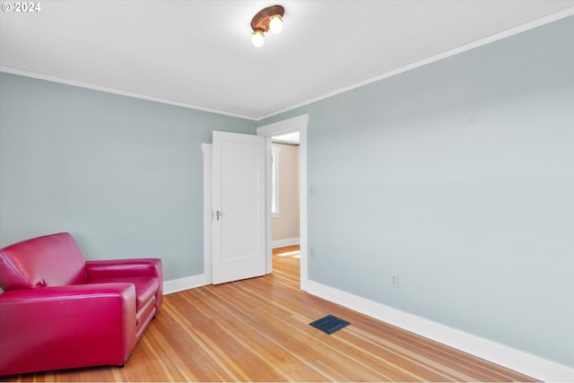 sitting room featuring crown molding and hardwood / wood-style floors