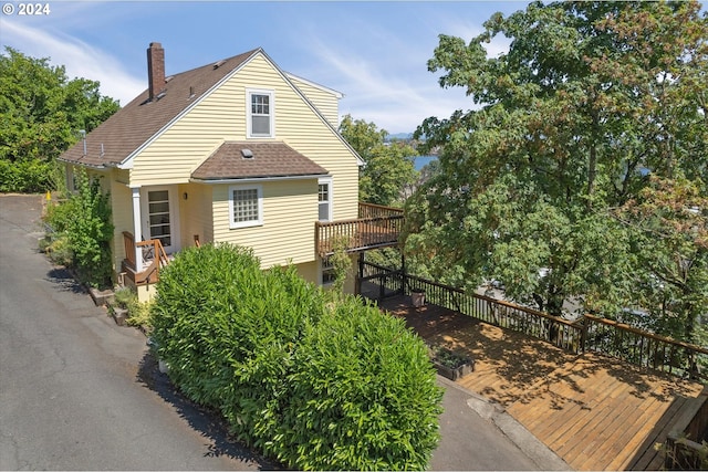 view of property exterior with a deck