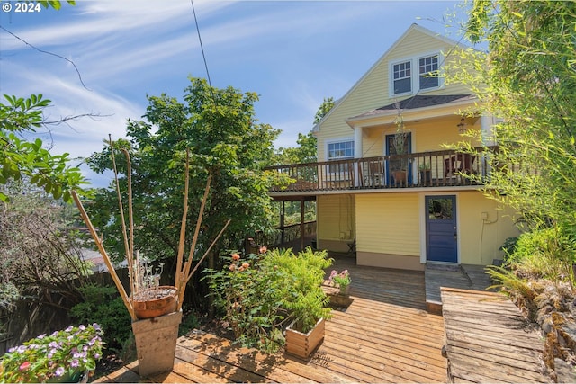 rear view of property with a wooden deck