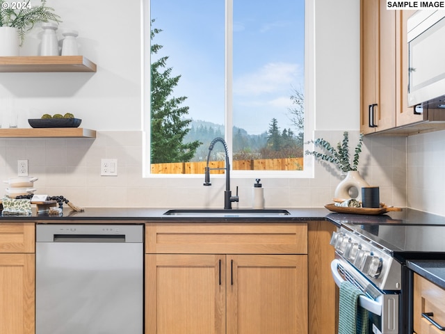 kitchen featuring backsplash, stainless steel appliances, and sink