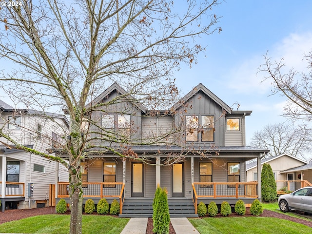 view of front of home featuring covered porch and a front yard