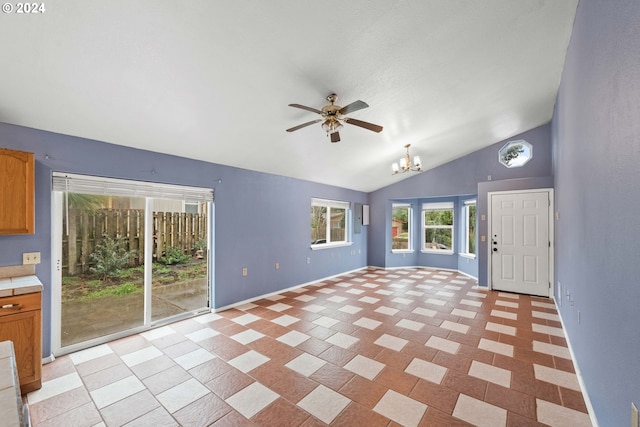 interior space with ceiling fan with notable chandelier and vaulted ceiling