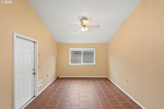 unfurnished room with vaulted ceiling and ceiling fan