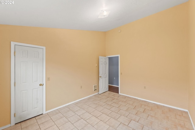 empty room featuring high vaulted ceiling