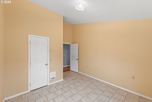 empty room featuring high vaulted ceiling