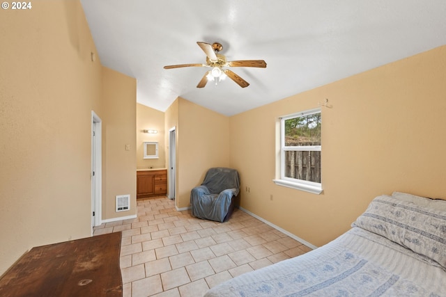 bedroom featuring connected bathroom, ceiling fan, light tile patterned flooring, and vaulted ceiling