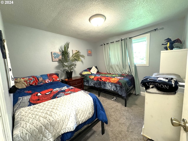 carpeted bedroom with a textured ceiling