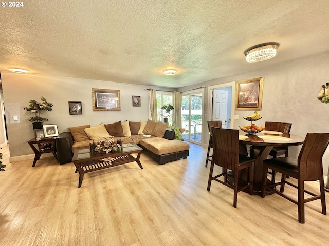 living room featuring light hardwood / wood-style floors and a textured ceiling