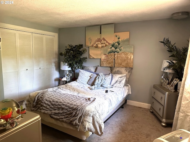 carpeted bedroom with a textured ceiling and a closet