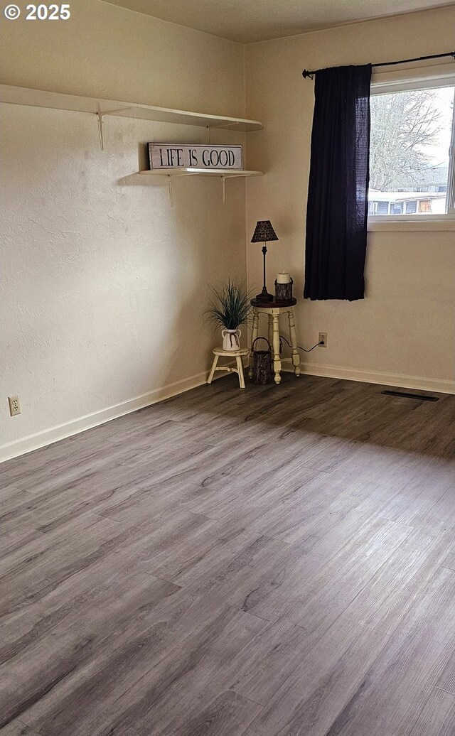 unfurnished bedroom featuring hardwood / wood-style floors and ensuite bathroom