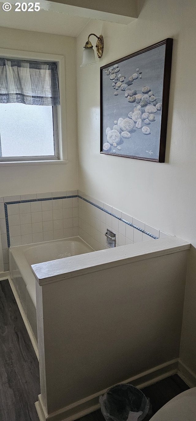 full bathroom featuring wood finished floors and a garden tub