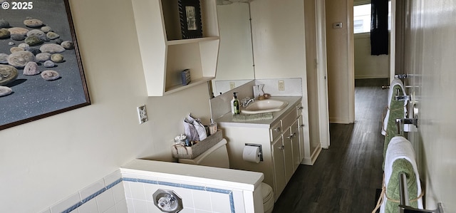 half bath with vanity and wood finished floors