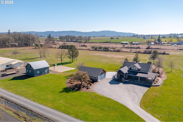 drone / aerial view featuring a rural view and a mountain view