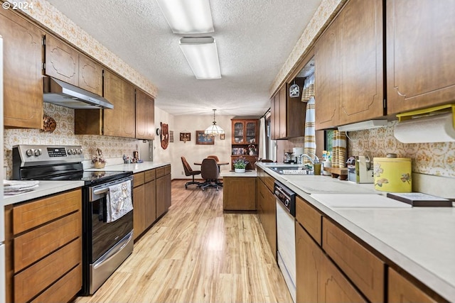 kitchen with hanging light fixtures, exhaust hood, light wood-type flooring, a textured ceiling, and stainless steel range with electric cooktop