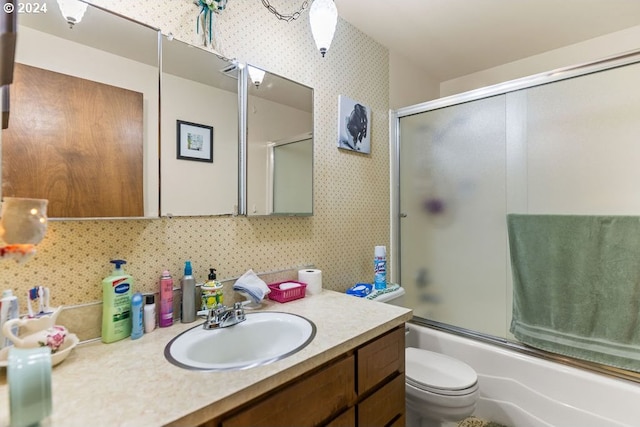 full bathroom with shower / bath combination with glass door, vanity, and toilet