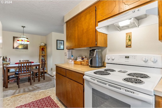 kitchen featuring light carpet, a textured ceiling, electric range, and hanging light fixtures