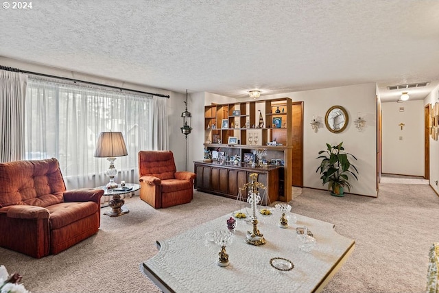 carpeted living room with a textured ceiling