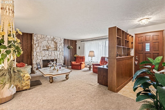 living room with light carpet, a textured ceiling, and a fireplace