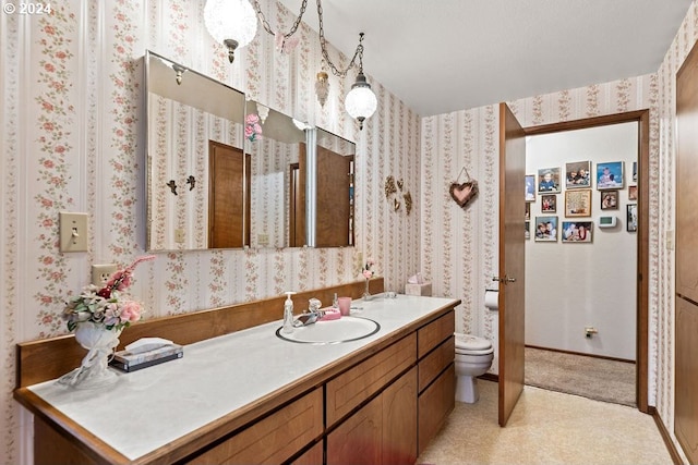 bathroom featuring vanity and toilet