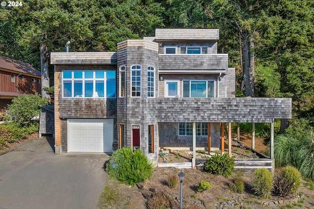 contemporary house featuring a carport and a garage