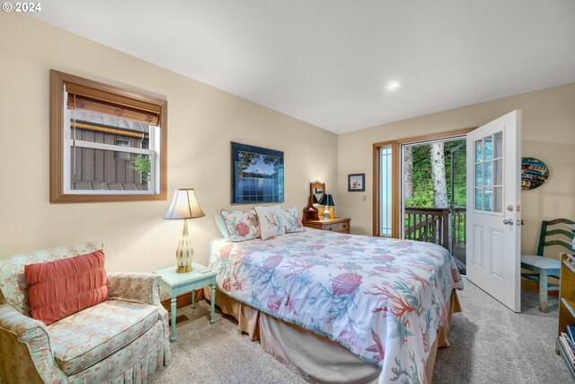 bedroom featuring access to outside and light colored carpet