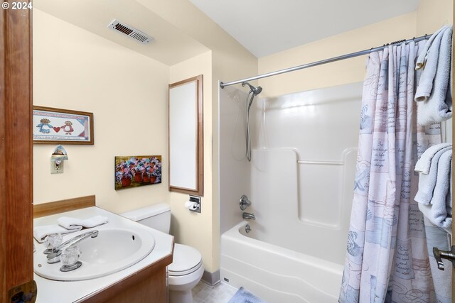 full bathroom featuring vanity, toilet, and shower / tub combo with curtain