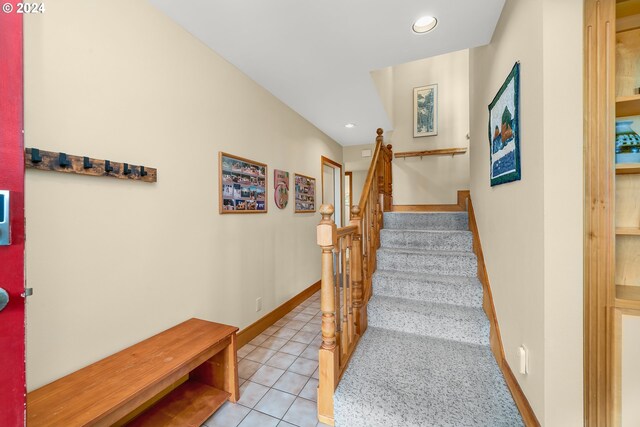 stairway with tile patterned flooring