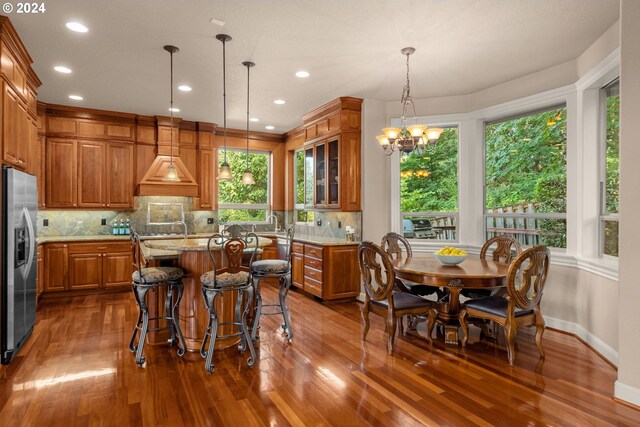 kitchen with sink, appliances with stainless steel finishes, light stone counters, and tasteful backsplash