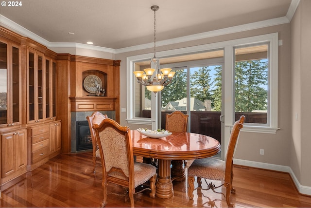 dining room featuring ornamental molding, an inviting chandelier, and wood-type flooring