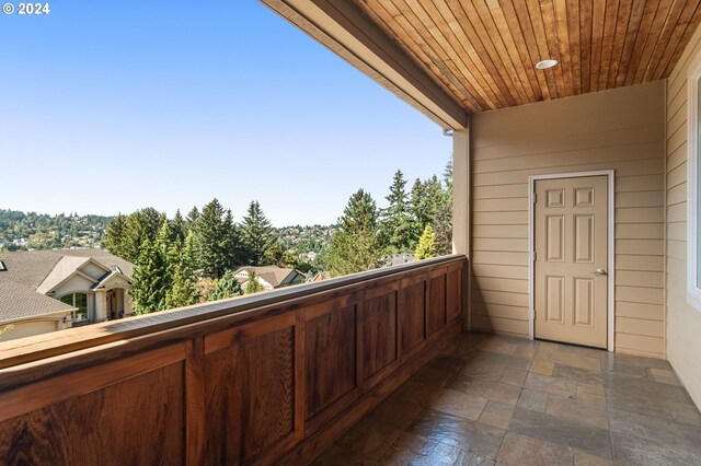 carpeted office with built in desk and crown molding