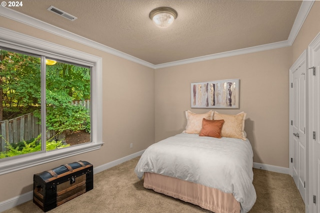 bedroom featuring a textured ceiling, light carpet, and crown molding