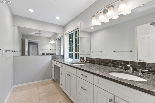 bathroom with vanity, backsplash, and tile patterned flooring