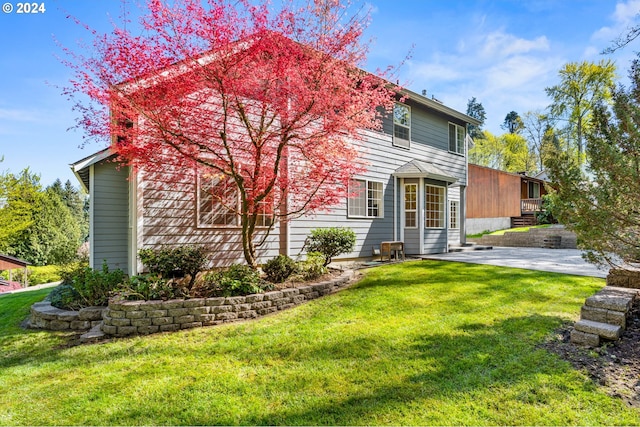 view of front of property with a front yard and a patio area