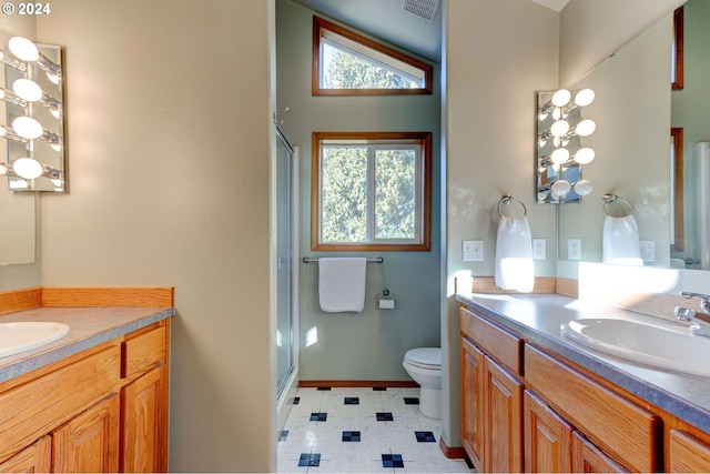 bathroom featuring toilet, vanity, lofted ceiling, and walk in shower