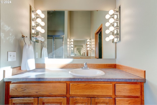 bathroom featuring vanity and an enclosed shower