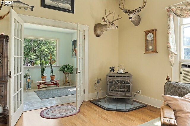 interior space featuring a wood stove, french doors, and hardwood / wood-style flooring