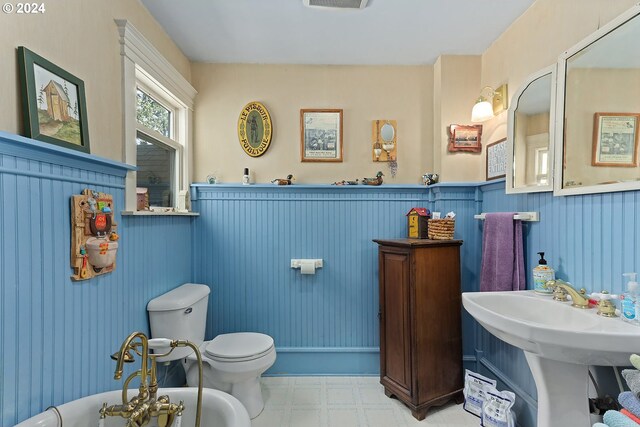 bathroom with toilet and tile patterned flooring