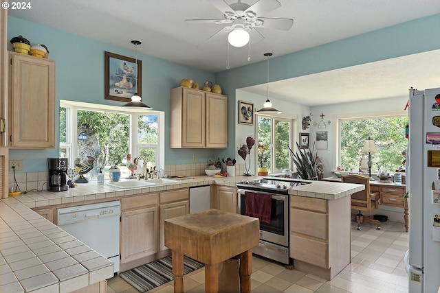 kitchen with tile counters, sink, light brown cabinets, and white appliances